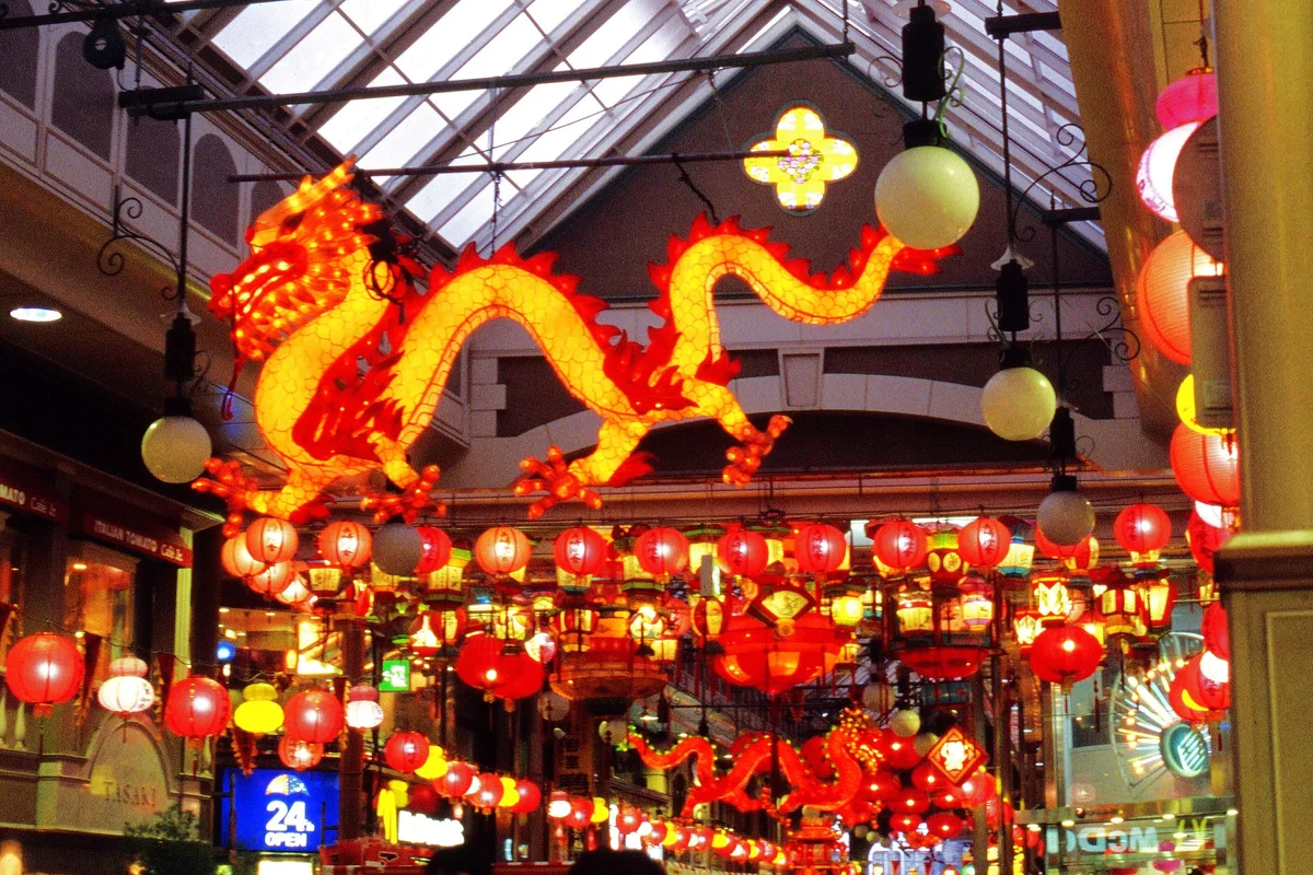 Red lanterns and a large dragon lantern hanging over the Hamanomachi shopping arcade in Nagasaki at night