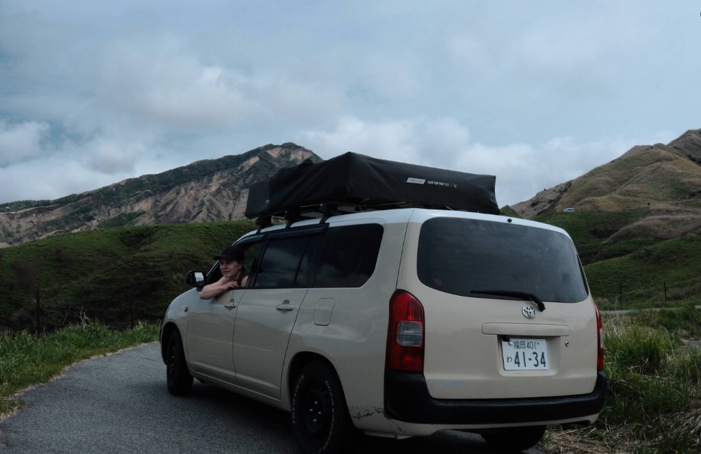 Toyota Probox with roof tent on mountain road, Mt Aso